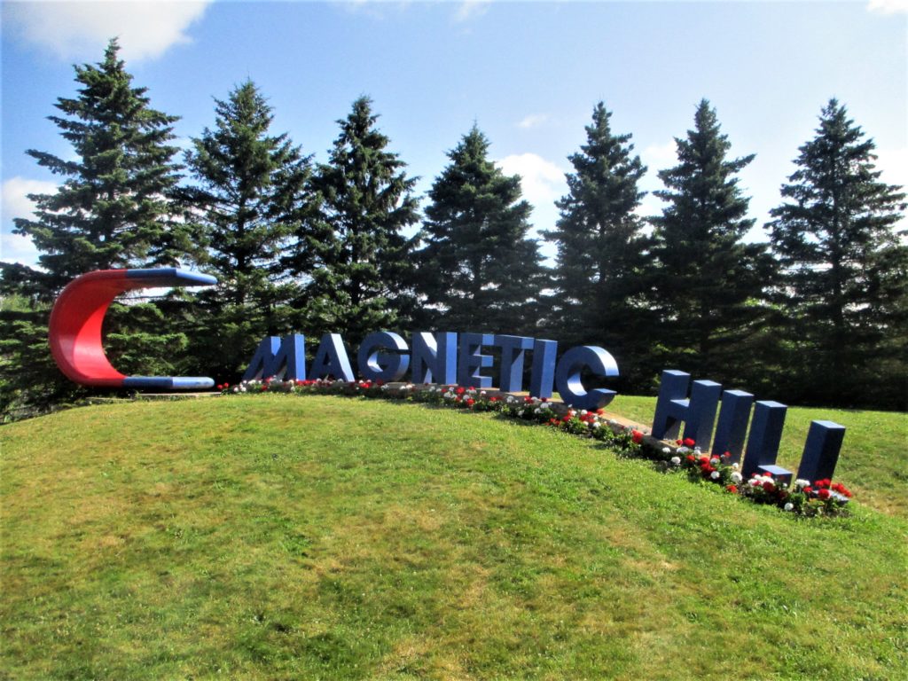 Magnetic Hill, New Brunswick, where cars appear to defy gravity by rolling uphill, exemplifying the unique phenomenon that attracts visitors worldwide.